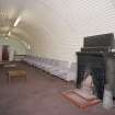 Interior view of sergeants mess, lounge showing brick built fireplace and seating arrangement