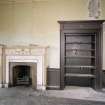 Interior. Library, detail of fireplace and cupboard.