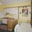 Interior. First floor. Private or family kitchen with 1970's units showing dining area and portrait of Ninian Brodie of Brodie