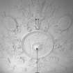 Interior. Former entrance hall plaster ceilng depicting suits of Roman armour