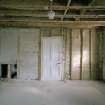 Interior. N range, ground floor W room E wall showeing lathe and plaster