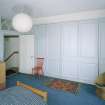 Interior. Fourth floor. Front bedroom showing panelled cupboards closed