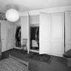 Interior. Fourth floor. Front bedroom showing panelled cupboards open