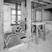 Interior. first floor of mill, view from NW of belt-pulley arrangement linked to gear-cupboard (on ground floor below), towards S end of the mill