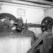 Interior. ground floor of mill, view from E of gear cupboard showing arrangement of gears and shafts transferring power from the water wheel (on the other side of the wall) to belt pulleys