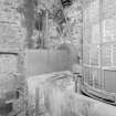 Interior. ground level in West kiln, where the traditional kiln firebox, invert and wire-mesh floor have been removed and replaced with a rotary sirocco grain-drying kiln built by H J H King & Co of Nailsworth, Gloucestershire.  This view (from W) shows the furnace (left) and tower (right)