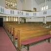 Interior. View from N showing pews and galleries