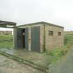 View from SE of a single bomb store shed showing doors and part of the loading gantry.