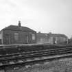 View from E of outbuilding and shed at end of N-bound platform at W side of station