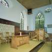 Interior, view of raised platfom from NW with communion table and pulpit