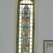 Interior, detail of SW stained glass window depicting farming