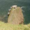 View from SW over cliffs to searchlight emplacement on rock stack.  Also visible are sections of timber access steps.