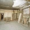 Interior. View from NE showing remains of wooden panelling and fireplace on 1st floor of warehouse ('Room 10')