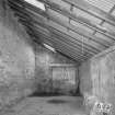Interior. View from SW at NE end of lean-to area at NE side of warehouse ('Room 3')