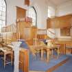 Interior.
View from NE showing font, pulpit, communion table, collection paddles and salvers.