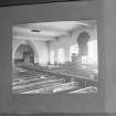 Interior.
Detail of pre 1910 photograph showing church before re-ordering with the pulpit central on the south wall and 19th century pews.