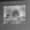 Interior.
Detail of c.1910 photograph showing re-ordered church with new pulpit, chancel panelled using original pews, medieval font and new chancel fittings.