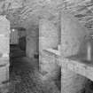Interior, view of lower ground floor vaulted wine cellar with bins