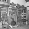 Interior, detail of studio bookcases and stove