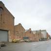 View from WSW along S side of former plumbers' shops with former engine works beyond.