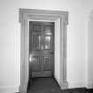 Interior. Ground floor Detail of entrance hallway door with stone roll moulded lugged architrave the original front door
