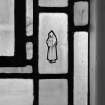 Interior, detail of hooded figure on reused stained glass by Barnett and Son
