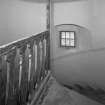 Interior, detail of main spiral staircase at attic level with flat balusters and newel