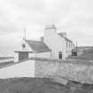 View from E of coastguard station, with houses behind