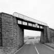 View of railway bridge from NW, showing granite abutments and single steel truss