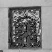 Interior. Detail of celtic bell in niche with wrought iron gate