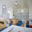 Interior. View from NE showing pulpit, pews and W gallery