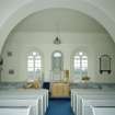 Interior. View from NNW in N aisle showing archway and central pulpit