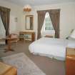 Interior.
First floor, SE bedroom, view from NW showing 1930's furniture.