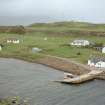 Muck, Port Mor and Pier Cottage. School, quay, cottage and gear store. View from WSW.