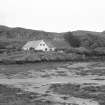 Muck, Port Mor. Port Mor House Hotel and building (NM 4208 7938) on terrace above. View from SE.