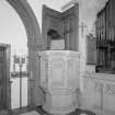 Interior.
Detail of gothic tracery pulpit and panelling of 1903 by H O Tarbolton.
