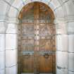 Interior.
Detail of main S oak door exterior from S with low relief panels designed by Mrs Meredith Williams and carved by W & A Clow c. 1926.