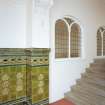 Interior, first floor landing detail of tiled dado and internal window into church