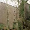 View from E of NE side of mill, with two arches of the tailrace visible (bottom foreground)