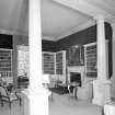 Interior. View of ground floor library from SE through columned screen