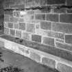 Interior. Detail of main porch stone bench and metal coat rack