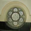 Interior. 
Detail of stained glass in wheel window at gallery level.