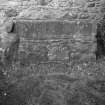Detail of stone grave slab inset into wall.