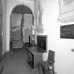 Interior. 
View of entrance lobby from S showing memorials and gallery stairs.