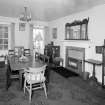 Interior, view of dining room from North East showing fireplace