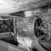 Interior. Detail in water-wheel house of gearing and vertcial line shaft taking power to mill