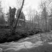 View from E of NE side of mill, partly obscured by trees, with Lornty Burn in foreground