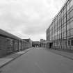 View from W showing disused office block (right), Broadloom Weaving Department (left), and former Madelvic Car Factory (including pend) in distance