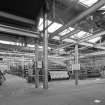 Interior. General view within Broadloom Weaving Department, showing rows of broad looms (many with 20-foot beams).  These were part of the Paper Trade Products section, and produced wire cloth much of which was used to produce calender drums for paper making machines