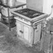 Interior. 
Detail of old gas-fired stove in kitchen area.